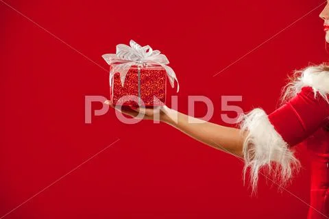 Christmas. Photo Of Santa Claus Gloved Hand With Red Gift Box