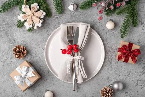 Christmas place setting on gray table. Stock Photos