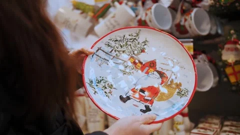 Christmas plate, dish, utensils. present. close-up. Woman looks at Christmas Stock Footage 255877141