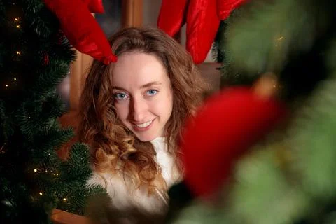 Christmas portrait looking at camera frame by evergreen pine tree festive atm Foto stock