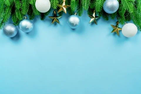 Christmas present and pine tree with xmas decoration on blue background Stock Photos