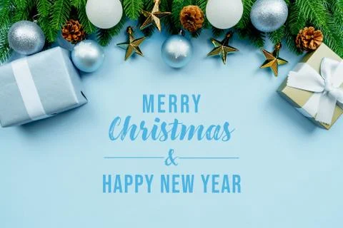 Christmas present and pine tree with xmas decoration on blue background Stock Photos