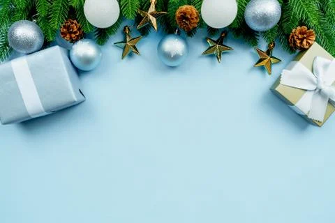 Christmas present and pine tree with xmas decoration on blue background Stock Photos