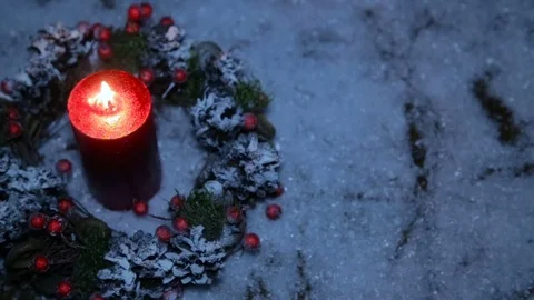 Christmas present on the background of artificial snow and a lighted candle Stock Footage 82608581