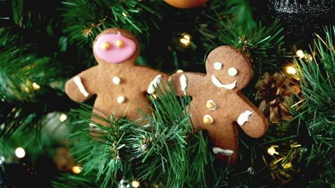 Christmas present cookie gingerbread man on spruce branches, LED light glowing. Stock Footage 211330698