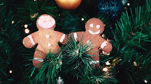 Christmas present cookie gingerbread man on spruce branches, LED light glowing. Stock Footage 220911813