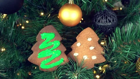 Christmas present cookie gingerbread tree on spruce branches, LED light glowing Stock Footage 211330495