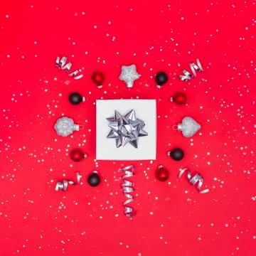 Christmas present with decorations on red background Stock Photos