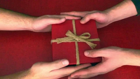 Christmas present exchange with red and brown boxes on a red surface Stock Footage 144701065