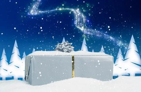 A Christmas present in front of wintry background Stock Photos