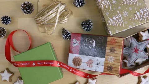 Christmas present packing in the box hands from above top view Stock Footage 70073805