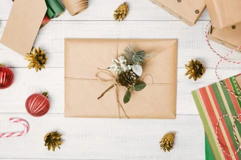 Christmas presents and gift boxes wrapped in kraft paper, envelope on a woode Stock Photos