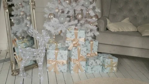 Christmas presents stand under the tree. pink and orange boxes with light Stock-Footage 85230223