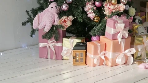 Christmas presents stand under the tree. pink and orange boxes with light 動画素材 85268268