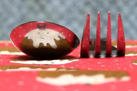 Christmas pudding reflected in spoon and fork Stock Photos