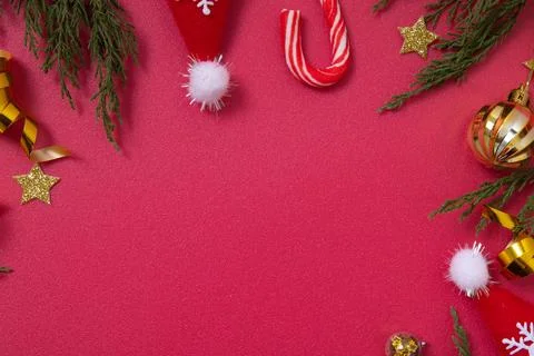 Christmas red background with decorative elements and green branches flat l.. Stock Photos