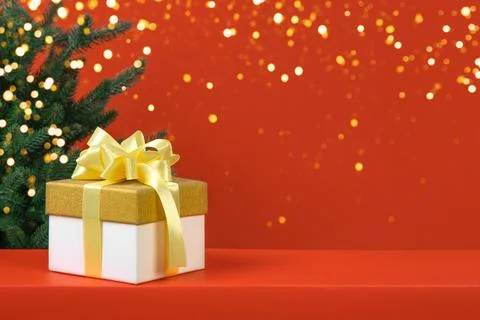 Christmas red background with tree and gift box Stock Photos