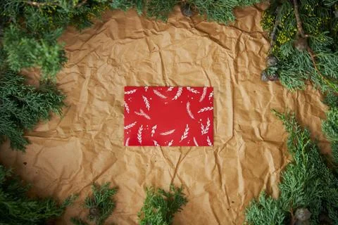 Christmas red card with an empty space in the center of the frame of spruce Stock Photos