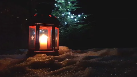 Christmas red glowing lantern close up with evergreen tree Stock Footage 98235908