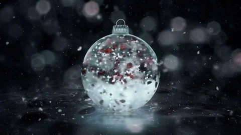 Christmas Rotating Grey Noir Ice Glass Bauble snow red petals background loop Stock Footage 82431419
