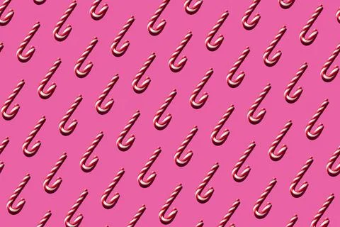 Christmas seamless candy cane pattern on pink background Stock Photos