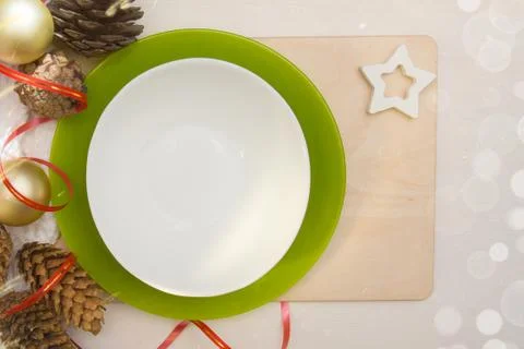 Christmas server. A white empty plate stands on the table with New Year's dec Stock Photos