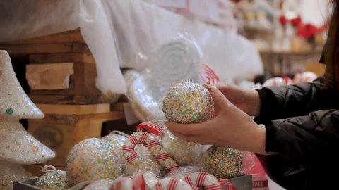 Christmas shopping, decorations, Fair. close-up. woman chooses Christmas festive Stock Footage 255877314