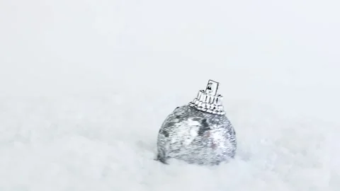 Christmas silver gray Christmas tree toy with glitter on the snow, gift rotation Stock Footage 222390099