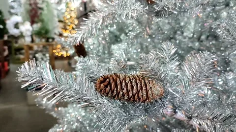 Christmas silver tree decorated with cones and with a bokeh lights background Stock-Footage 164954571