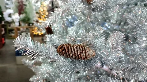 Christmas silver tree decorated with cones and with a bokeh lights background Video stock 164954596