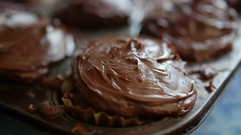 Christmas sprinkles falling in slow motion on chocolate cupcake red white green Video stock 150674839