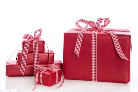 Christmas: stack of red gift boxes with bow and ribbon, isolated on white bac Stock Photos