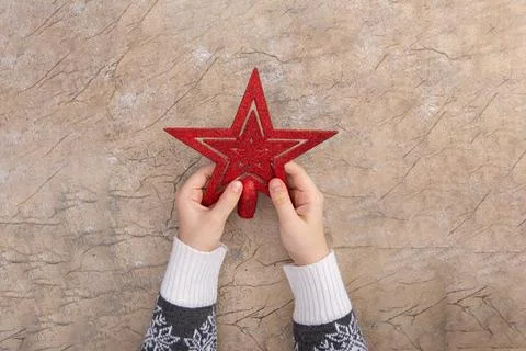 Christmas star decor in a woman's hand. Christmas and New year greeting card Stock Photos