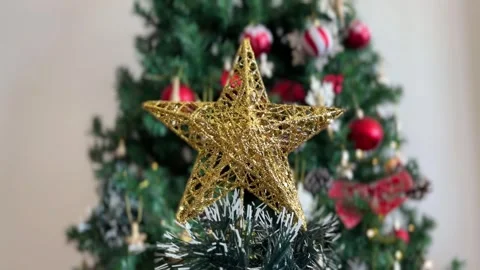 Christmas star rotating with blurred tree Stock Footage 341611589