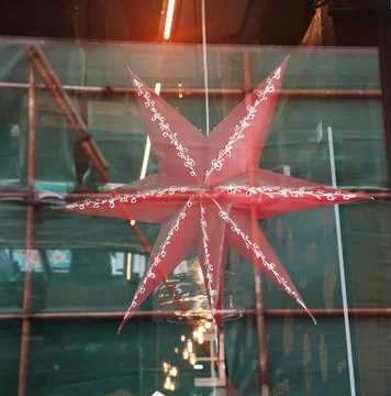 Christmas star in the window. Stock Photos