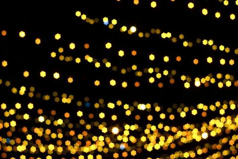 Christmas starry bokeh light in yellow gold color Foto stock