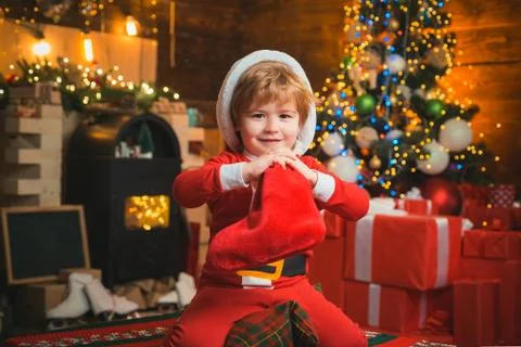 Christmas stocking concept. Child cheerful face got gift in christmas sock Stock Photos