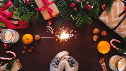 Christmas table decorated with a background of hands holding a Sparkler Vídeo Stock 70362239