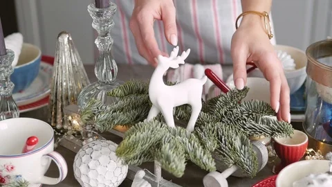 Christmas table decoration. festive table setting. Female hands decorate the Stock-Footage 122920570