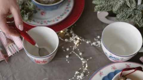 Christmas table decoration. festive table setting. Female hands decorate the Stockbeeldmateriaal 123342684