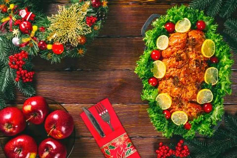 Christmas table dinner time with roasted meats decorated in Christmas style.  Stock Photos