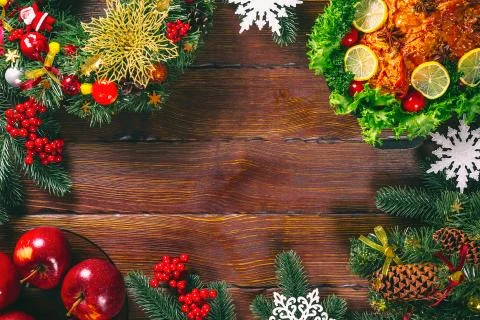 Christmas table dinner time with roasted meats decorated in Christmas style.  Stock Photos