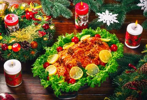 Christmas table dinner time with roasted meats decorated in Christmas style.  Stock Photos