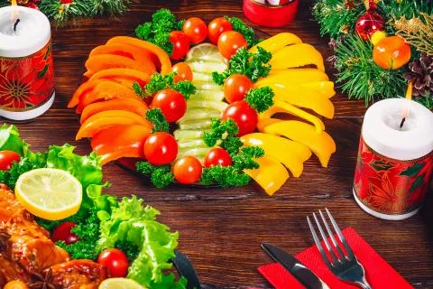 Christmas table dinner time with roasted meats decorated in Christmas style.  Stock Photos