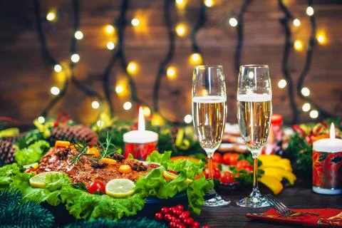 Christmas table dinner time with roasted meats decorated in Christmas style w Stock Photos