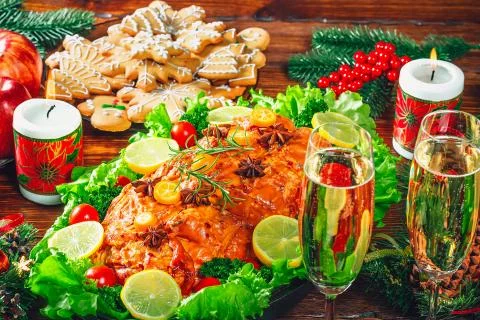 Christmas table dinner time with roasted meats decorated in Christmas style w Stock Photos
