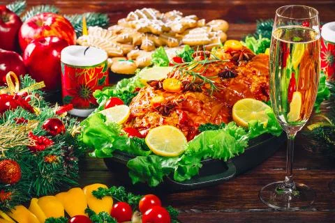 Christmas table dinner time with roasted meats decorated in Christmas style w Stock Photos
