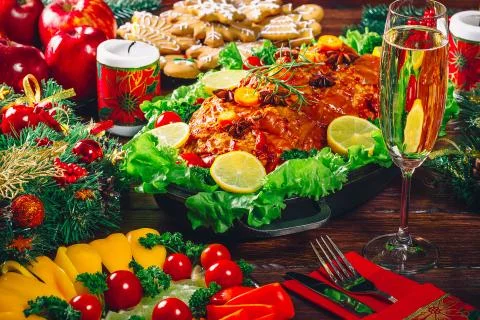 Christmas table dinner time with roasted meats decorated in Christmas style w Stock Photos