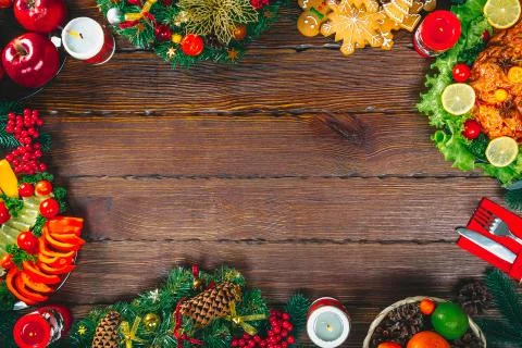 Christmas table dinner time with roasted meats decorated in Christmas style.  Stock Photos