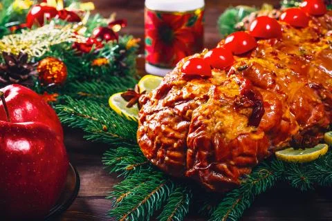 Christmas table dinner time with roasted meats, candles and New Year dcor. Ba Stock Photos